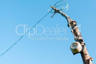 Old round socket on a pole,  sky background.