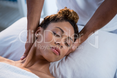 Woman receiving neck massage from physiotherapist