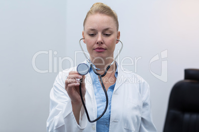 Female doctor holding stethoscope