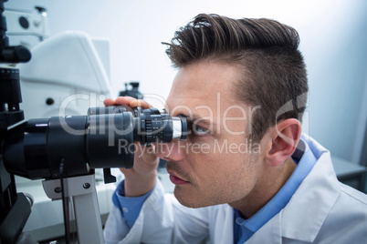 Optometrist looking through biomicroscope