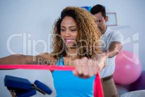 Physiotherapist giving shoulder massage to patient