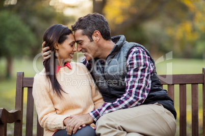 Couple embracing on bench