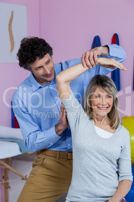 Physiotherapist giving hand massage to patient