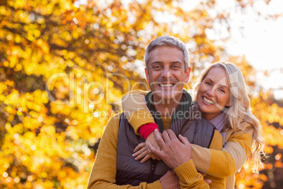 Portrait of smiling couple standing at park