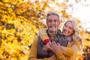 Portrait of smiling couple standing at park