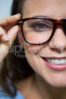 Female customer wearing spectacles in optical store
