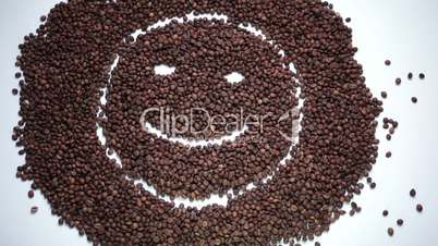 Happy emoticon appearing from coffee beans