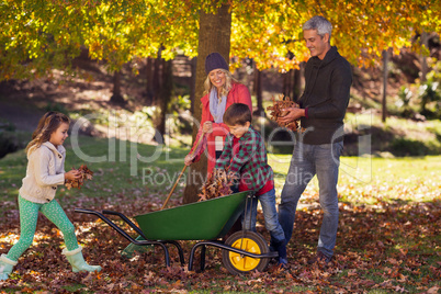 Family picking up autumn leaves
