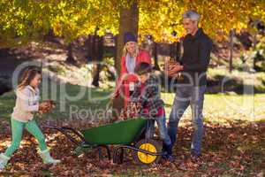 Family picking up autumn leaves