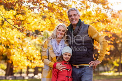 Portrait of happy family at park during autumn