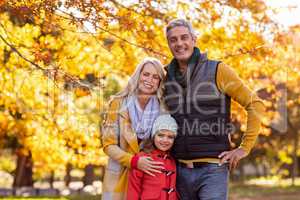 Portrait of happy family at park during autumn