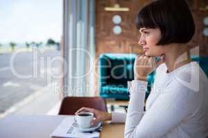 Woman sitting in cafeteria