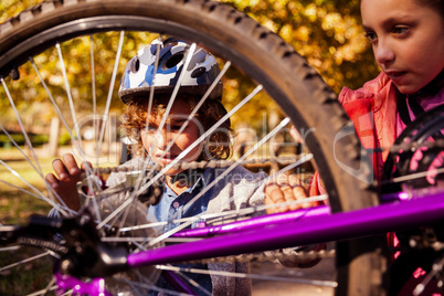 Siblings repairing mountain bike