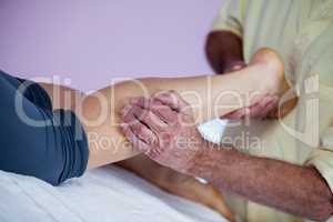 Physiotherapist giving leg massage to a woman