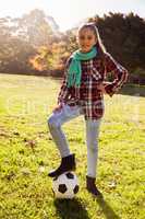Portrait of smiling girl with soccer ball in park