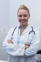 Portrait of female doctor standing in clinic