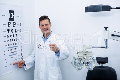 Optometrist pointing at eye chart