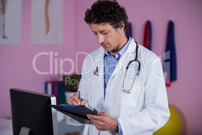 Physiotherapist writing on clipboard