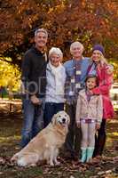 Happy family standing with dog at park