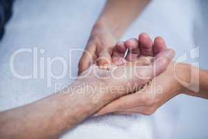 Physiotherapist giving hand massage to a patient