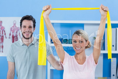 Physiotherapist correcting position of female patient