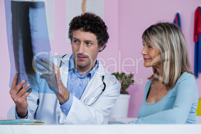 Physiotherapist explaining x-ray to patient