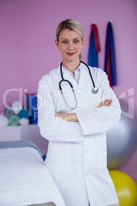 Portrait of physiotherapist standing with arms crossed