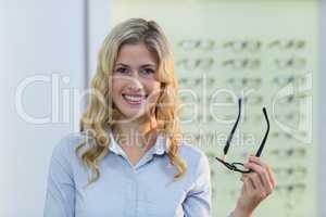 Beautiful female customer holding spectacles