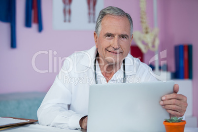 Portrait of physiotherapist using laptop