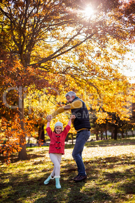 Playful father with daughter at park