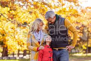 Smiling family at park during autumn