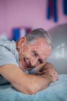 Portrait of senior man lying on a massage bed