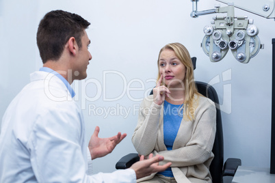 Optometrist interacting with female patient