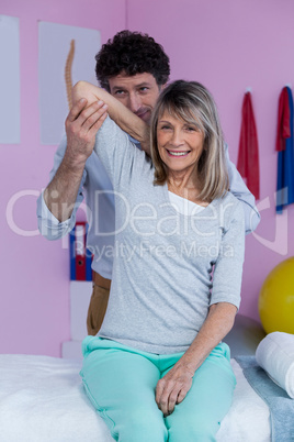 Physiotherapist giving hand massage to patient