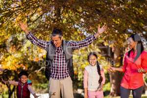 Cheerful family enjoying during autumn