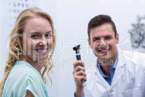 Female patient smiling with optometrist in background
