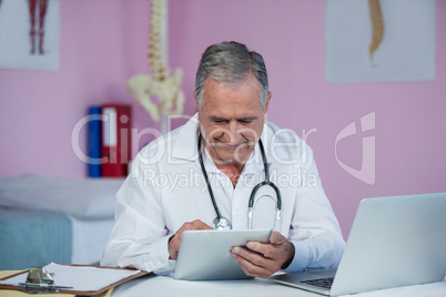 Physiotherapist using digital tablet