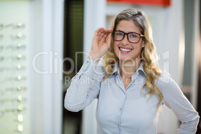 Smiling female customer trying spectacles