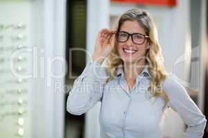 Smiling female customer trying spectacles