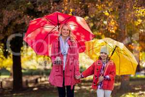 Portrait of happy mother and daughter at park