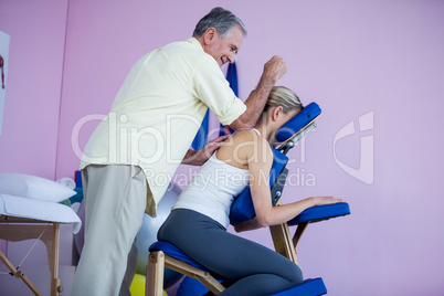Physiotherapist giving back massage to a patient