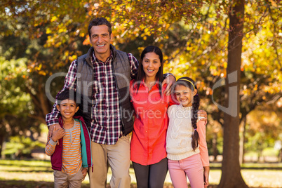 Portrait of smiling family standing at park