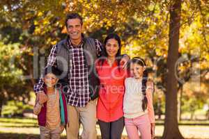 Portrait of smiling family standing at park