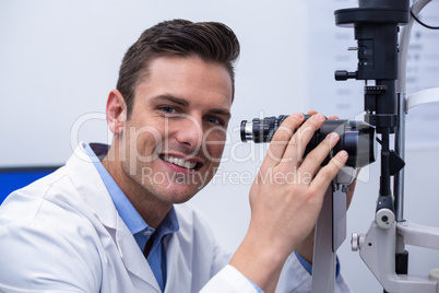 Optometrist looking through biomicroscope