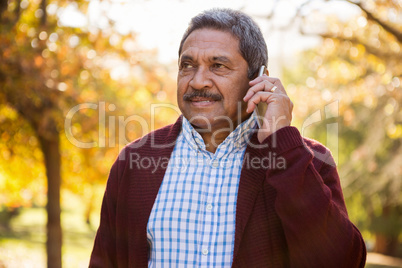 Man talking on cellphone at park