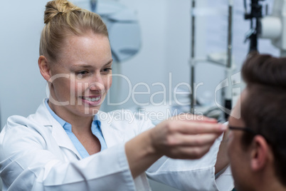 Female optometrist prescribing spectacles to patient