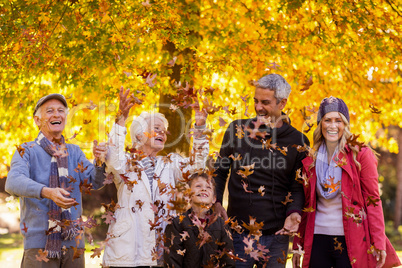 Happy family enjoying at park during autumn