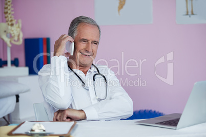 Physiotherapist talking on mobile phone