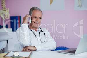 Physiotherapist talking on mobile phone