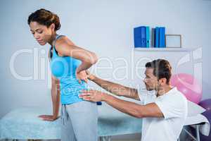 Physiotherapist examining womans back